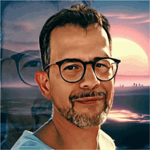 a man with glasses and a beard is smiling