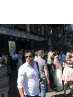 a man in a white shirt is standing in front of a crowd of people