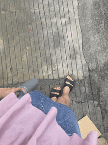 a person 's feet are shown on a concrete surface