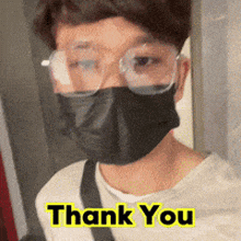 a man wearing glasses and a face mask says thank you