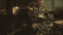 a man in a camouflage uniform is touching another man 's face