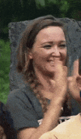 a woman wearing a t-shirt that says ' i love you ' on it is smiling