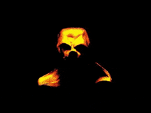 a skull is glowing in the dark in a painting .