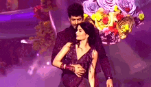 a man and a woman are dancing together on a stage .