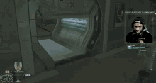a man playing a video game with the letters gr on the bottom left