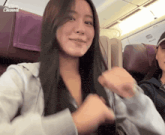 a woman sitting on a plane with the word channel on the bottom left