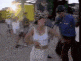 a blurry picture of a woman in a white dress and a man in a blue uniform