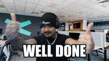 a man wearing headphones and a hat that says blizzard gives a thumbs up