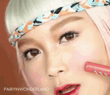 a close up of a woman wearing a headband and lipstick