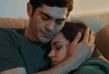 a man and a woman are hugging each other and the man is holding the woman 's head