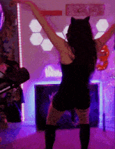 a woman is dancing in front of a neon sign that says woof you