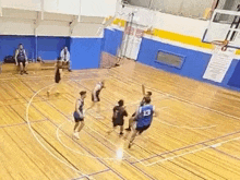 a group of men are playing basketball on a court .