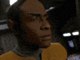 a close up of a man wearing a yellow jacket