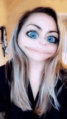 a woman with blue eyes is making a face with her mouth open .