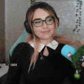 a woman wearing glasses and headphones has the number 1000 on the screen