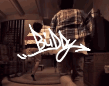 the word buddy that is on a person 's back