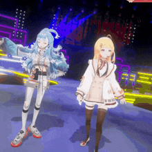 a girl with blue hair is standing next to a girl with blonde hair on a stage