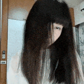 a woman with long hair is wearing headphones