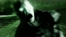 a close up of a person 's face in the dark with a green background .