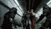 a group of soldiers are standing next to each other in a tunnel .