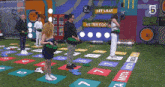 a group of people playing a game with a sign that says let 's eat on it