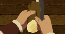 a person is holding a piece of wood with a knife