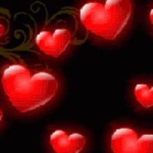 a bunch of red hearts are floating in the air on a black background