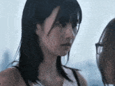 a close up of a woman 's face looking at another woman 's face .