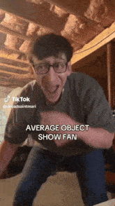 a man wearing glasses is making a funny face and says average object show fan
