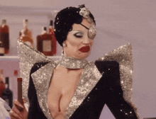 a woman in a very revealing outfit is holding a cigar