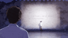 a man is standing in front of a wall that says in the hustle and bustle of downtown