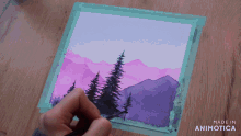 a person is painting a landscape with purple mountains and trees and the words made in animotica on the bottom