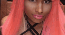 a close up of a woman wearing a pink wig and lipstick .