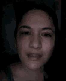 a close up of a woman 's face with a smile on it