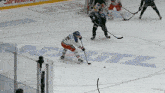 a hockey game is being played on a rink with the word ritz in the background