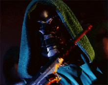 a superhero with a green hood is holding a sword