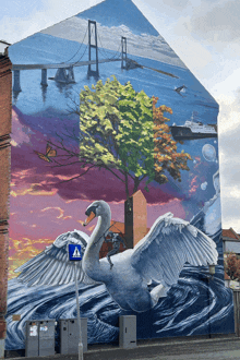 a swan is painted on the side of a building next to a blue sign that says a