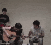 a man playing an acoustic guitar in front of a group of people with imgflip.com at the bottom