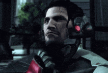 a man in a futuristic armor with a red light on his head