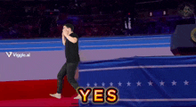 a man walking on a red carpet with the word yes written on it