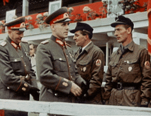 a group of men in military uniforms are standing in a line