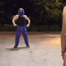 a person wearing a helmet and blue pants is standing on a basketball court .