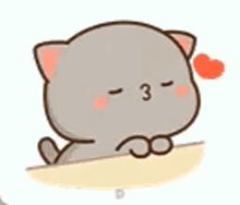 a cartoon cat is sitting on a table with a heart on its nose .