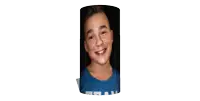 a young boy wearing a blue shirt with the word real on it smiles for the camera