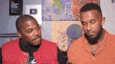 two men are talking in front of a sign that says people 's choice awards winners
