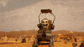 a cartoon character is sitting in a chair with a skull on his head