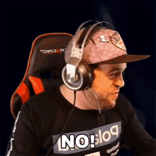 a man wearing headphones and a hat with the word no on his shirt