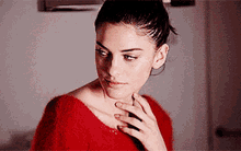 a woman in a red sweater is looking down