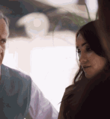 a man and a woman are looking at something in a blurry photo