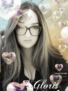 a woman wearing glasses is surrounded by heart shaped soap bubbles and the word gloris